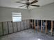 Main bedroom ready for renovation, featuring a ceiling fan, window and natural light at 4706 Lansing Ne St, St Petersburg, FL 33703