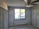 Construction view of the bedroom, featuring a large window with natural light, ready for renovation at 6220 Keller Dr, Port Richey, FL 34668