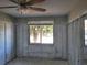 A construction view of the bedroom features a window letting in natural light, ready for renovation at 6220 Keller Dr, Port Richey, FL 34668