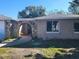 Charming single-story home featuring a unique stone archway and neutral-toned exterior at 6220 Keller Dr, Port Richey, FL 34668