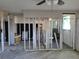 A construction view of the living room, with ceiling fan, shows potential for renovation at 6220 Keller Dr, Port Richey, FL 34668