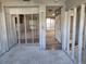 A demolition view of the living room shows access to other rooms, awaiting complete renovation at 6220 Keller Dr, Port Richey, FL 34668