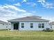 Spacious backyard featuring a covered patio, expansive lawn, and mature landscaping, perfect for outdoor entertaining at 6310 116Th E Ave, Parrish, FL 34219