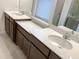 Elegant bathroom with double vanity sinks, quartz countertops, and a separate glass-enclosed shower at 6310 116Th E Ave, Parrish, FL 34219