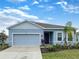 Charming single-Gathering home with a two-car garage, lush landscaping, and a well-maintained front lawn at 6310 116Th E Ave, Parrish, FL 34219