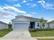 Charming single-Gathering home with a two-car garage, lush landscaping, and a well-maintained front lawn at 6310 116Th E Ave, Parrish, FL 34219