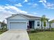 Charming single-Gathering home with a two-car garage, lush landscaping, and a well-maintained front lawn at 6310 116Th E Ave, Parrish, FL 34219