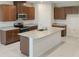 This kitchen features stainless steel appliances, granite countertops, and wooden cabinetry at 6310 116Th E Ave, Parrish, FL 34219