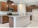 Modern kitchen featuring stainless steel appliances, granite countertops, and a spacious center island at 6310 116Th E Ave, Parrish, FL 34219