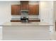 This kitchen features stainless steel appliances, wood cabinets, and a gray granite island at 6310 116Th E Ave, Parrish, FL 34219