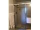 Bathroom featuring a tiled shower with sliding glass doors and updated fixtures at 6211 Timber Lake Dr # B4, Sarasota, FL 34243