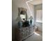 Bedroom showcasing a wicker dresser with a mirror, two lamps, and sunlit window at 6211 Timber Lake Dr # B4, Sarasota, FL 34243