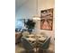 Cozy dining area featuring a glass top table with upholstered chairs, a chandelier, and decorative artwork at 6211 Timber Lake Dr # B4, Sarasota, FL 34243