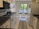 Bright kitchen featuring white cabinets, modern appliances, and a cozy breakfast nook area by the window at 6211 Timber Lake Dr # B4, Sarasota, FL 34243