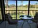 Enclosed Lanai featuring a glass table and comfortable seating with views of the beautiful golf course at 6211 Timber Lake Dr # B4, Sarasota, FL 34243