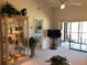 Inviting living room featuring a display case and access to a bedroom and outdoor living space at 6211 Timber Lake Dr # B4, Sarasota, FL 34243