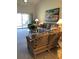 Inviting living room with comfortable wicker furniture, a ceiling fan, and sliding glass doors to the patio at 6211 Timber Lake Dr # B4, Sarasota, FL 34243
