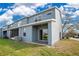 Exterior view of the building showing a back patio and a well-maintained lawn at 1580 Blue Magnolia Rd, Brandon, FL 33510