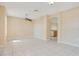 Spacious living room featuring tile flooring, ceiling fan, and an archway leading to the kitchen at 1580 Blue Magnolia Rd, Brandon, FL 33510