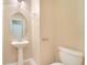 Stylish half bathroom featuring a pedestal sink and neutral tiling at 17530 Hugh Ln, Land O Lakes, FL 34638