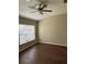 Spacious bedroom featuring hardwood floors, a ceiling fan, and a bright window at 2911 Bear Oak Dr, Valrico, FL 33594