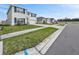 Street view of a two-story home with a well-maintained lawn, and blue shutters at 37127 Goffaux Loop, Zephyrhills, FL 33541