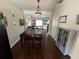 Inviting dining area leading to a comfortable living room; dark wood floors throughout the home at 4713 Jennings Bay Ct, Tampa, FL 33611