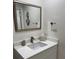 Bathroom with updated vanity and mirror, with coastal decor at 4780 Brittany S Dr # 111, St Petersburg, FL 33715