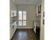 A butler's pantry features white cabinets, granite countertops, a wine fridge, and subway tile backsplash at 4780 Brittany S Dr # 111, St Petersburg, FL 33715