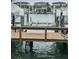 Dock view featuring boat lifts, waterfront access, and sturdy wooden construction at 4780 Brittany S Dr # 111, St Petersburg, FL 33715
