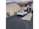 Exterior view of condo unit and assigned parking spot with white Mazda at 4780 Brittany S Dr # 111, St Petersburg, FL 33715