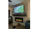 Cozy living room with entertainment area above the fireplace featuring a flat screen television at 4780 Brittany S Dr # 111, St Petersburg, FL 33715
