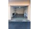 Interior garage with epoxy flooring, shelves, ladder, and storage containers at 4780 Brittany S Dr # 111, St Petersburg, FL 33715