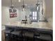 Well-lit kitchen featuring a spacious island with seating, modern pendant lighting, and stainless appliances at 4780 Brittany S Dr # 111, St Petersburg, FL 33715