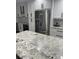 Modern kitchen features white cabinets, stainless steel appliances, and sleek granite countertops at 4780 Brittany S Dr # 111, St Petersburg, FL 33715