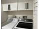 Laundry features side by side appliances and overhead storage at 4780 Brittany S Dr # 111, St Petersburg, FL 33715