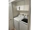 Laundry features side by side appliances and overhead storage at 4780 Brittany S Dr # 111, St Petersburg, FL 33715