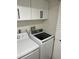 Laundry features side by side appliances and overhead storage at 4780 Brittany S Dr # 111, St Petersburg, FL 33715