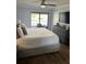 Cozy main bedroom featuring a ceiling fan and a sliding glass door that leads to a private patio at 4780 Brittany S Dr # 111, St Petersburg, FL 33715