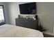 Bright main bedroom featuring a ceiling fan, a balcony, and a gray dresser with decor accents at 4780 Brittany S Dr # 111, St Petersburg, FL 33715