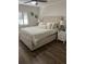 Main bedroom boasts hardwood floors, a large window, and stylish decor, offering comfort and elegance at 4780 Brittany S Dr # 111, St Petersburg, FL 33715
