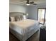 Comfortable main bedroom featuring a large white bed, gray accents, and a sliding glass door at 4780 Brittany S Dr # 111, St Petersburg, FL 33715