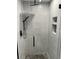 The shower features stylish marble tile, a rain shower head, and built-in niches for storage at 4780 Brittany S Dr # 111, St Petersburg, FL 33715