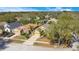 An aerial view of a mustard yellow home with a well-manicured lawn and a two-car garage at 7622 Hampshire Garden Pl, Apollo Beach, FL 33572