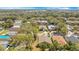 Sprawling community aerial view featuring many houses nestled among trees and verdant foliage at 7622 Hampshire Garden Pl, Apollo Beach, FL 33572