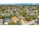 Neighborhood aerial view showcasing many houses nestled among trees and lush vegetation in a community setting at 7622 Hampshire Garden Pl, Apollo Beach, FL 33572