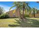 Exterior view of the yard with healthy grass, shrubbery and trees at 7622 Hampshire Garden Pl, Apollo Beach, FL 33572