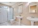 Modern bathroom featuring dual sinks and a glass-enclosed shower at 7622 Hampshire Garden Pl, Apollo Beach, FL 33572