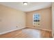 Well-lit bedroom with hardwood floors and a large window at 7622 Hampshire Garden Pl, Apollo Beach, FL 33572