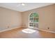 Cozy bedroom with hardwood floors and a large arched window at 7622 Hampshire Garden Pl, Apollo Beach, FL 33572